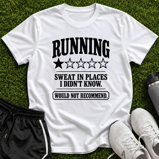 A white graphic t-shirt with black text reading 'RUNNING SWEAT IN PLACES I DIDN'T KNOW. WOULD NOT RECOMMEND.